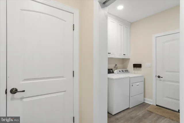 a view of a kitchen with white cabinets