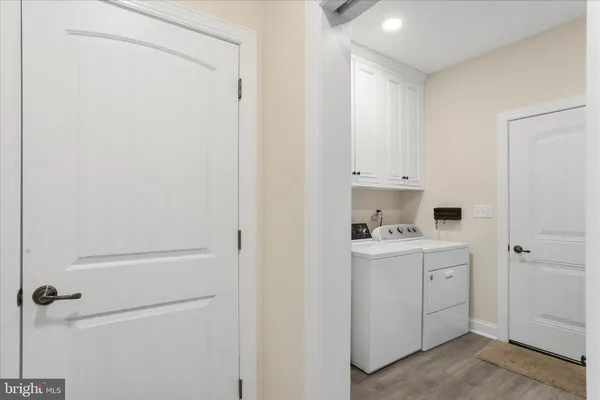 a kitchen with white cabinets and sink