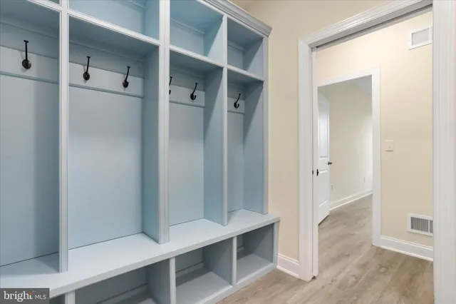 a view of walk in closet with empty racks