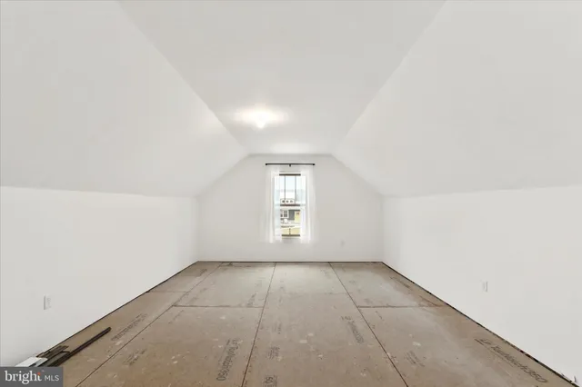 an empty room with a empty space and windows
