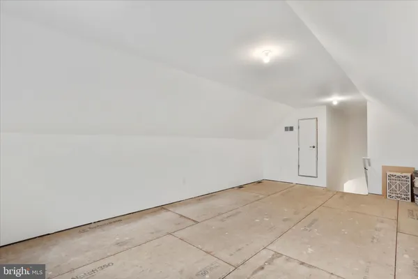an empty room with a empty space and windows