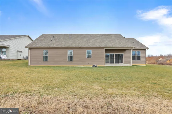 a house that has a big yard with wooden fence