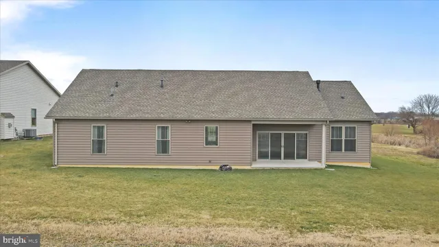a house that has a big yard with wooden fence