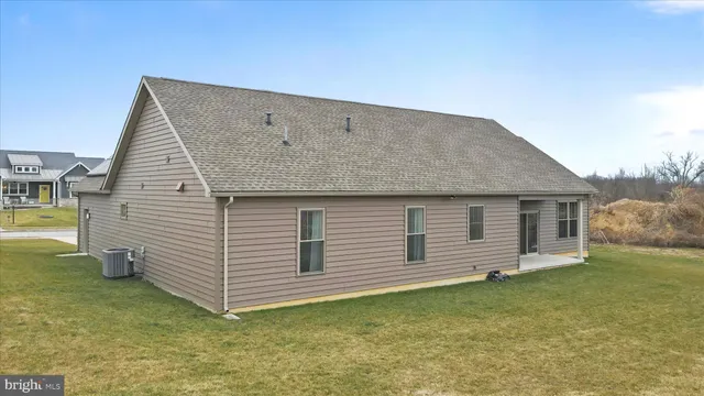 a front view of house with yard barbeque and outdoor seating
