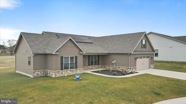 a front view of a house with a garden and yard
