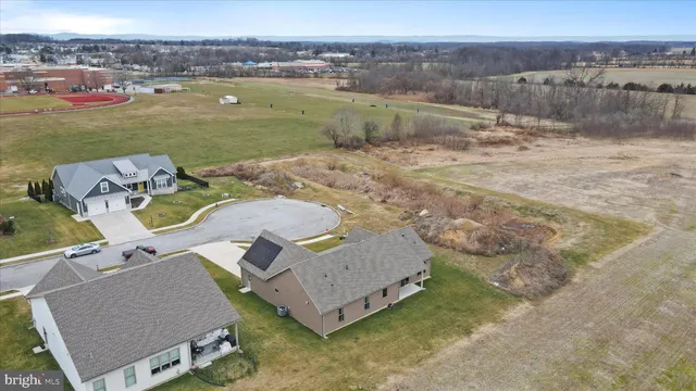 an aerial view of a house with a yard