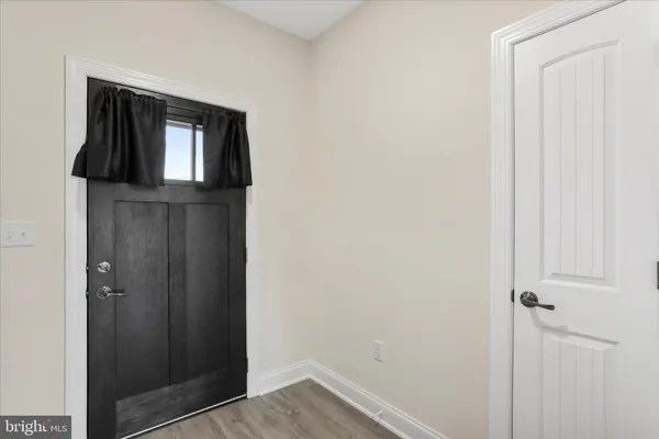 a view of kitchen with sink and refrigerator