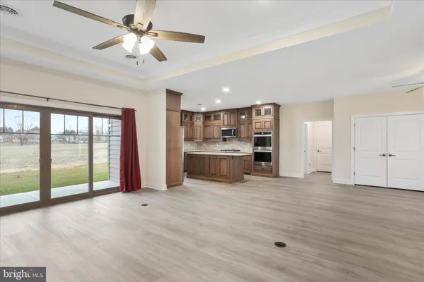 a view of an empty room with a fireplace and a window