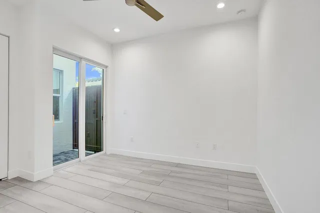 a view of a kitchen with a refrigerator and a sink