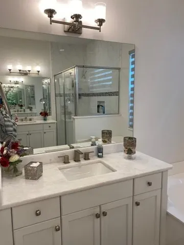 a bathroom with double sink and a mirror
