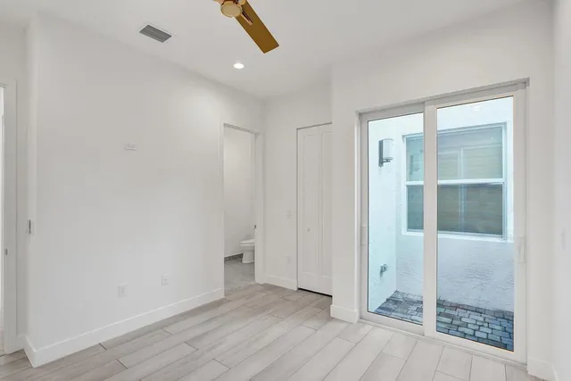 a large kitchen with kitchen island a sink stainless steel appliances and cabinets