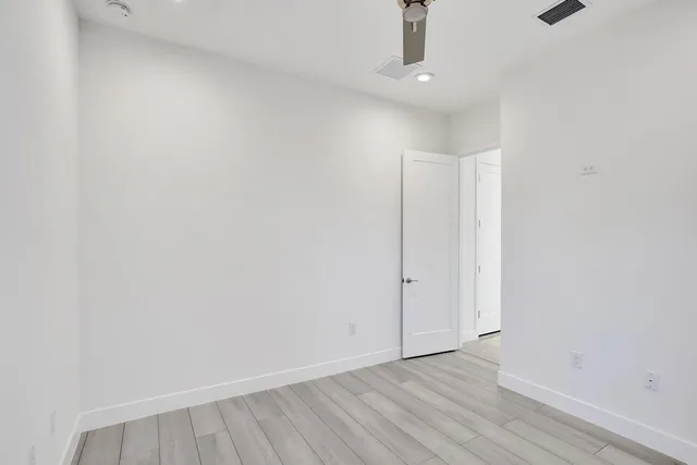 a large kitchen with granite countertop a large counter top a sink stainless steel appliances and cabinets