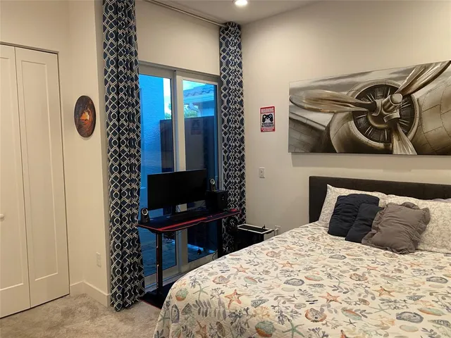 a bedroom with a bed and a mirror