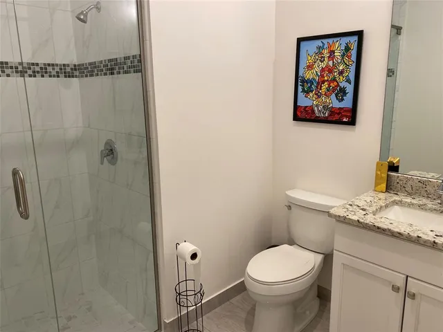 a bathroom with a toilet sink and vanity