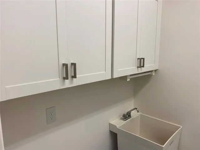 a bathroom with a sink and cabinets
