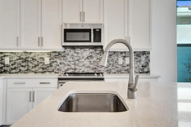 a view of a dining room with furniture large windows and wooden floor