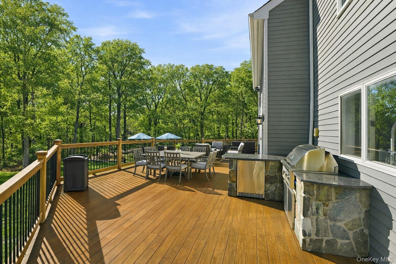 2 Hemlock Rise Armonk, NY 10504 - Photo 42 of 48 Outdoor kitchen featuring granite countertops, a built-in grill, and under counter fridge