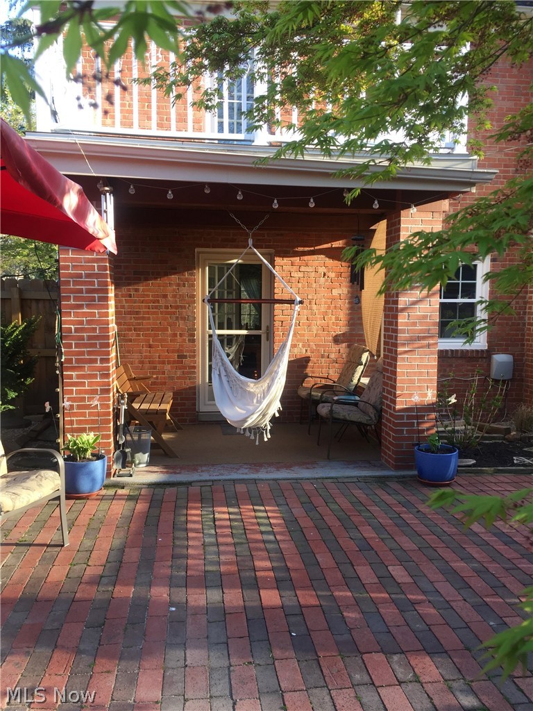 3433 Bradford Road Cleveland, OH 44118 - Photo 11 of 35 From the back gate is a view of the covered brick patio w/ concrete surface, while the two toned brick accents this private oasis. The Terrace above was rehabbed in 2017, w/ exterior surface, Trex spindles/railings, gutters & double downspouts for proper drainage.