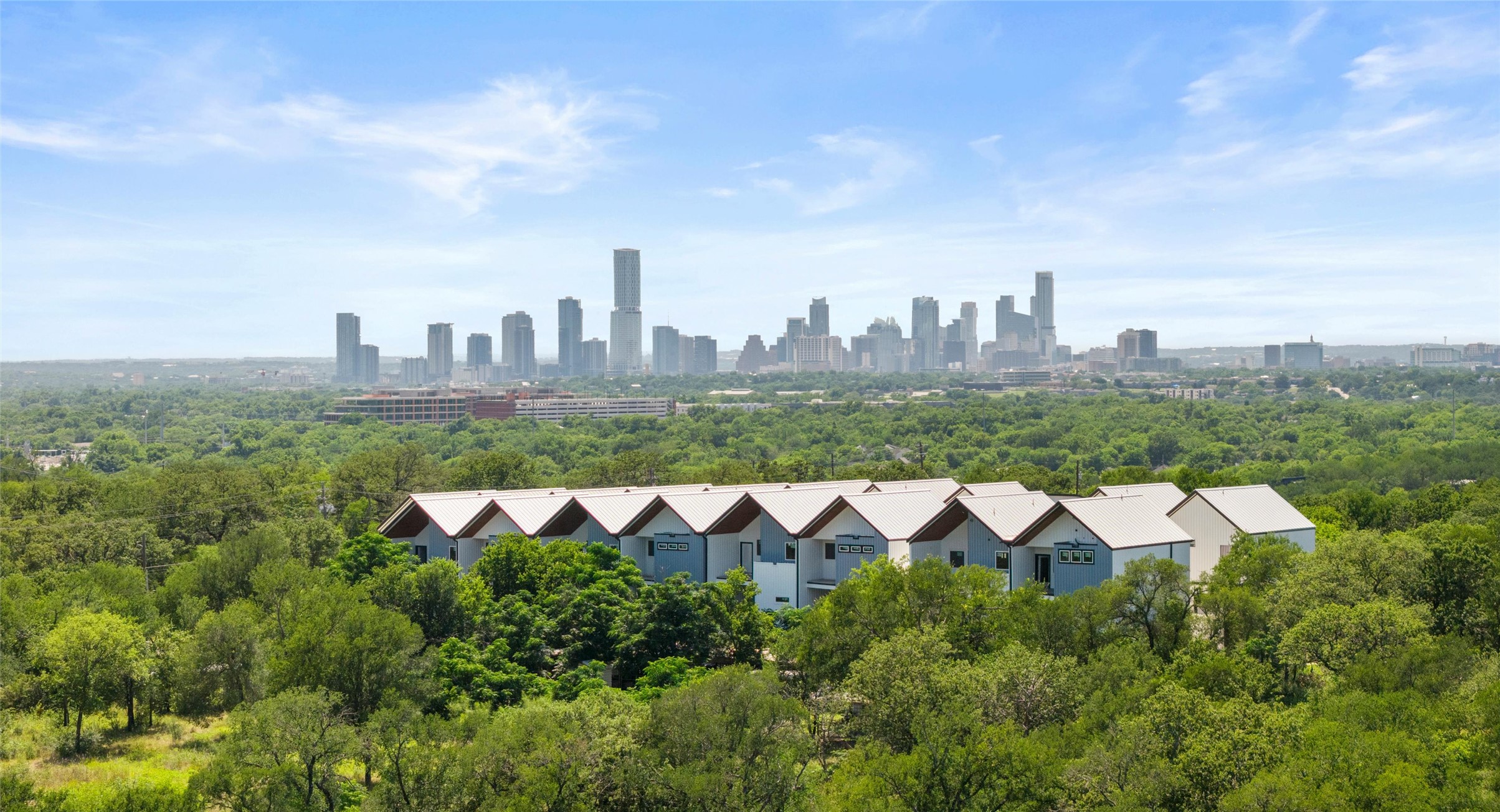5912 Harold Court, Unit 107 Austin, TX 78721 - Photo 22 of 35 Skyline views over the greenbelt: a green, private setting with the city in full view. Model No. 105 Shown.