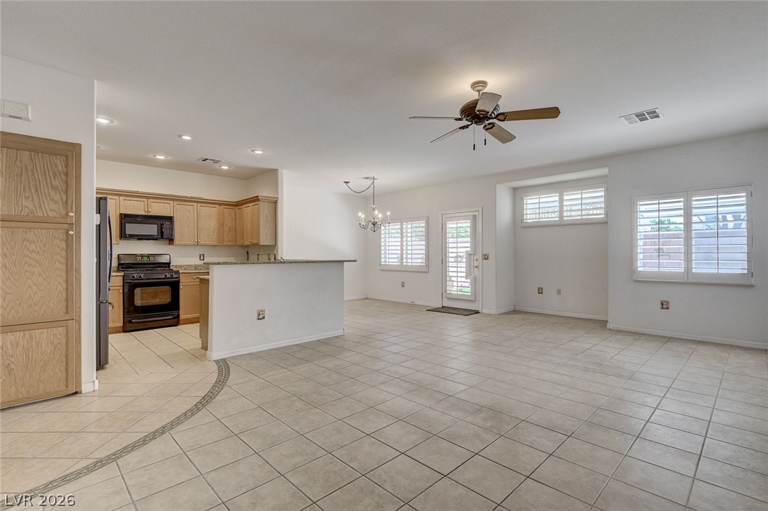 1479 Orange Jubilee Road Henderson, NV 89014 - Photo 5 of 36 An open concept living area transitions seamlessly from the well-appointed kitchen to a bright, versatile space.