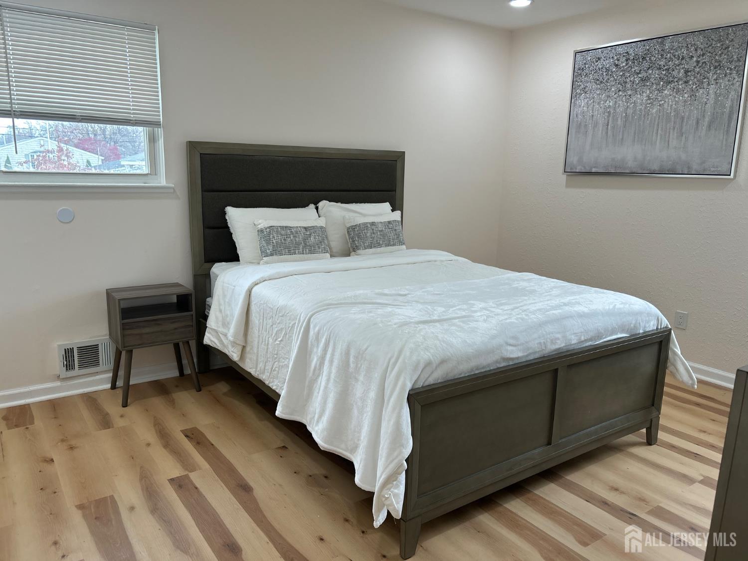 106 Boulevard West Old Bridge, NJ 07735 - Photo 21 of 34 a bed sitting in a bedroom next to a window with chair and lamp