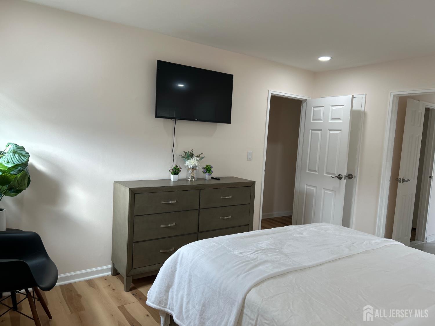 106 Boulevard West Old Bridge, NJ 07735 - Photo 22 of 34 a bedroom with a bed and a flat screen tv