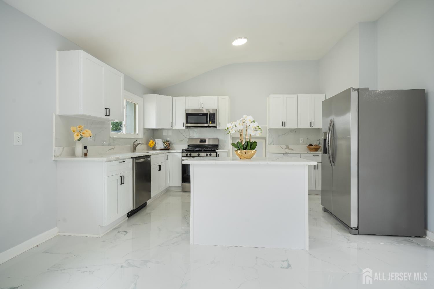 106 Boulevard West Old Bridge, NJ 07735 - Photo 7 of 34 a kitchen with stainless steel appliances a refrigerator sink stove and white cabinets