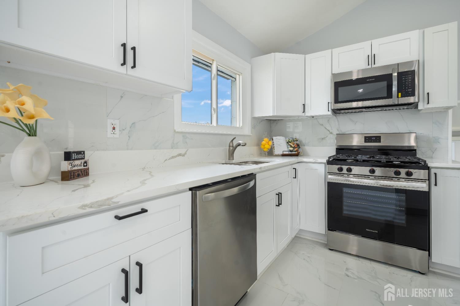 106 Boulevard West Old Bridge, NJ 07735 - Photo 9 of 34 a kitchen with stainless steel appliances white cabinets and a sink