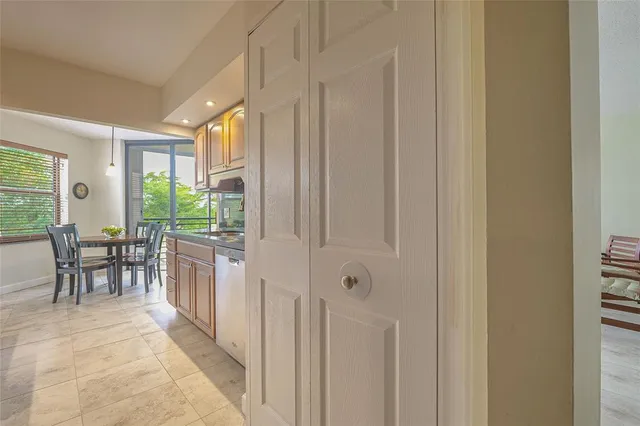 a view of a hallway with workspace and a window