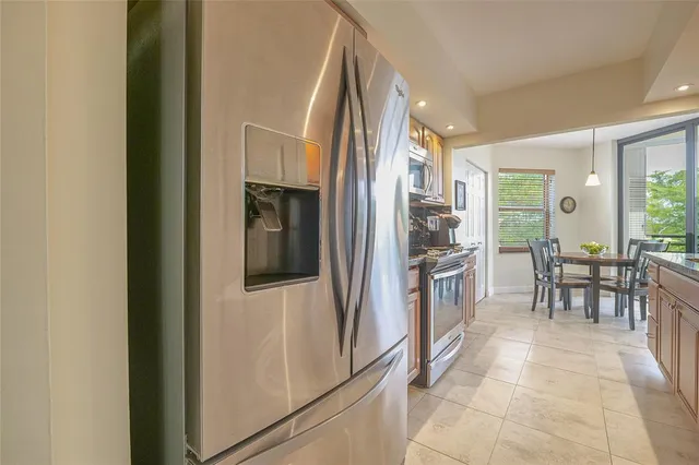 a spacious bedroom with a bed and a chandelier