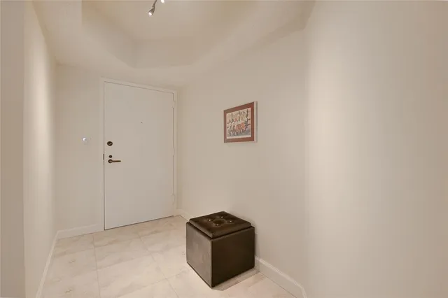 a bathroom with a granite countertop sink mirror and toilet