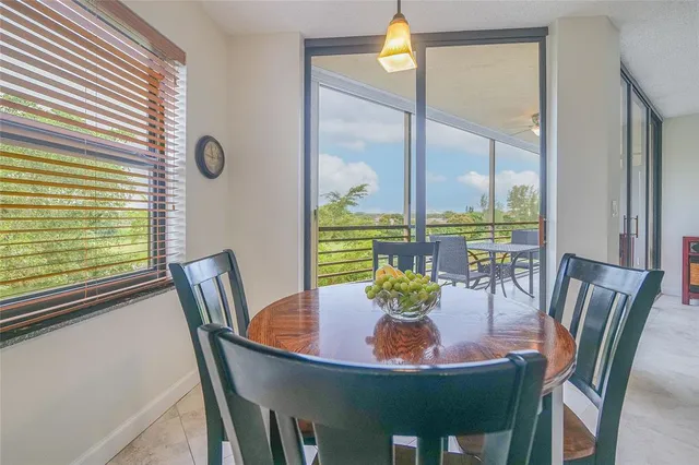 a living room with furniture large window and flat screen tv