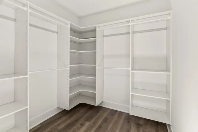 a view of walk in closet with empty racks