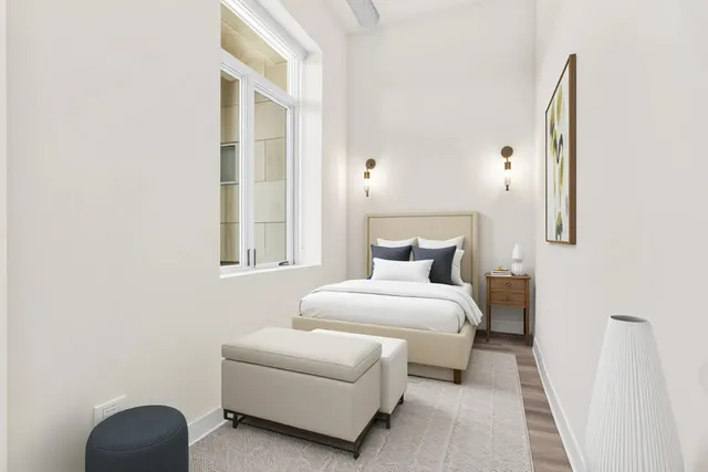 a bedroom with a bed and a window