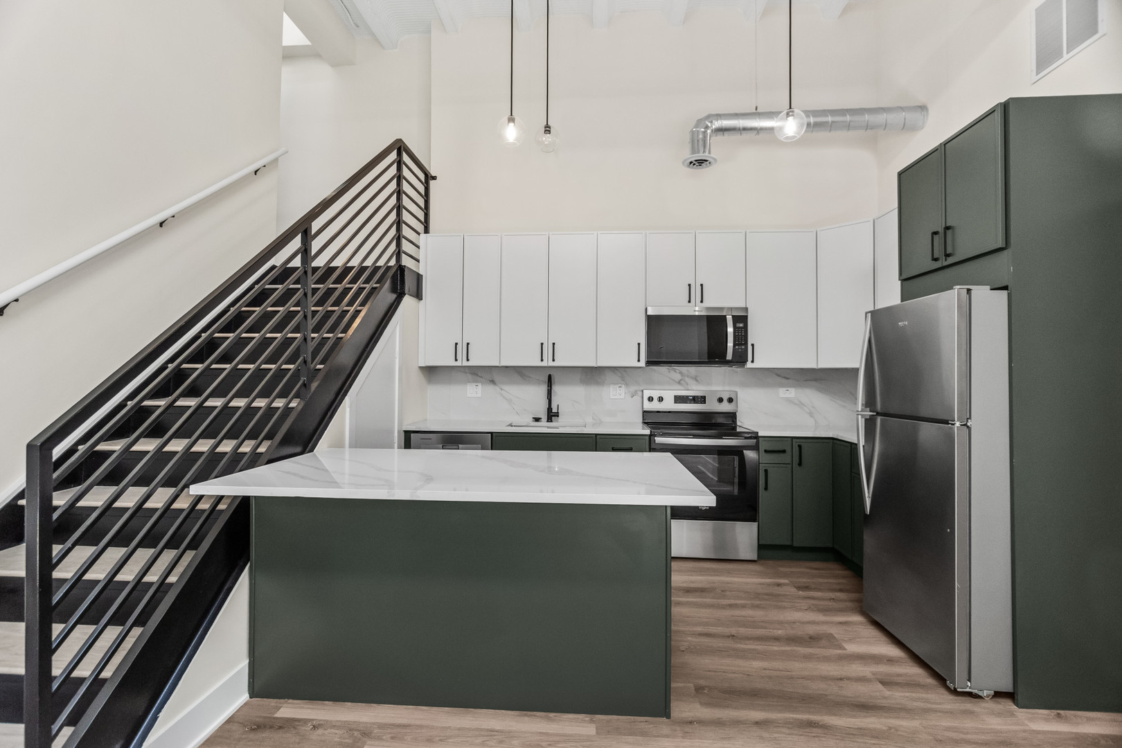 1453 Maple Avenue, Unit 201 Evanston, IL 60201 - Photo 7 of 25 a kitchen with stainless steel appliances kitchen island granite countertop a refrigerator a stove and a sink with wooden floor