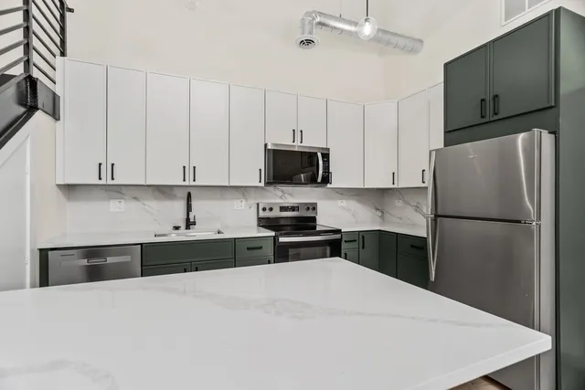 a kitchen with a refrigerator and a sink