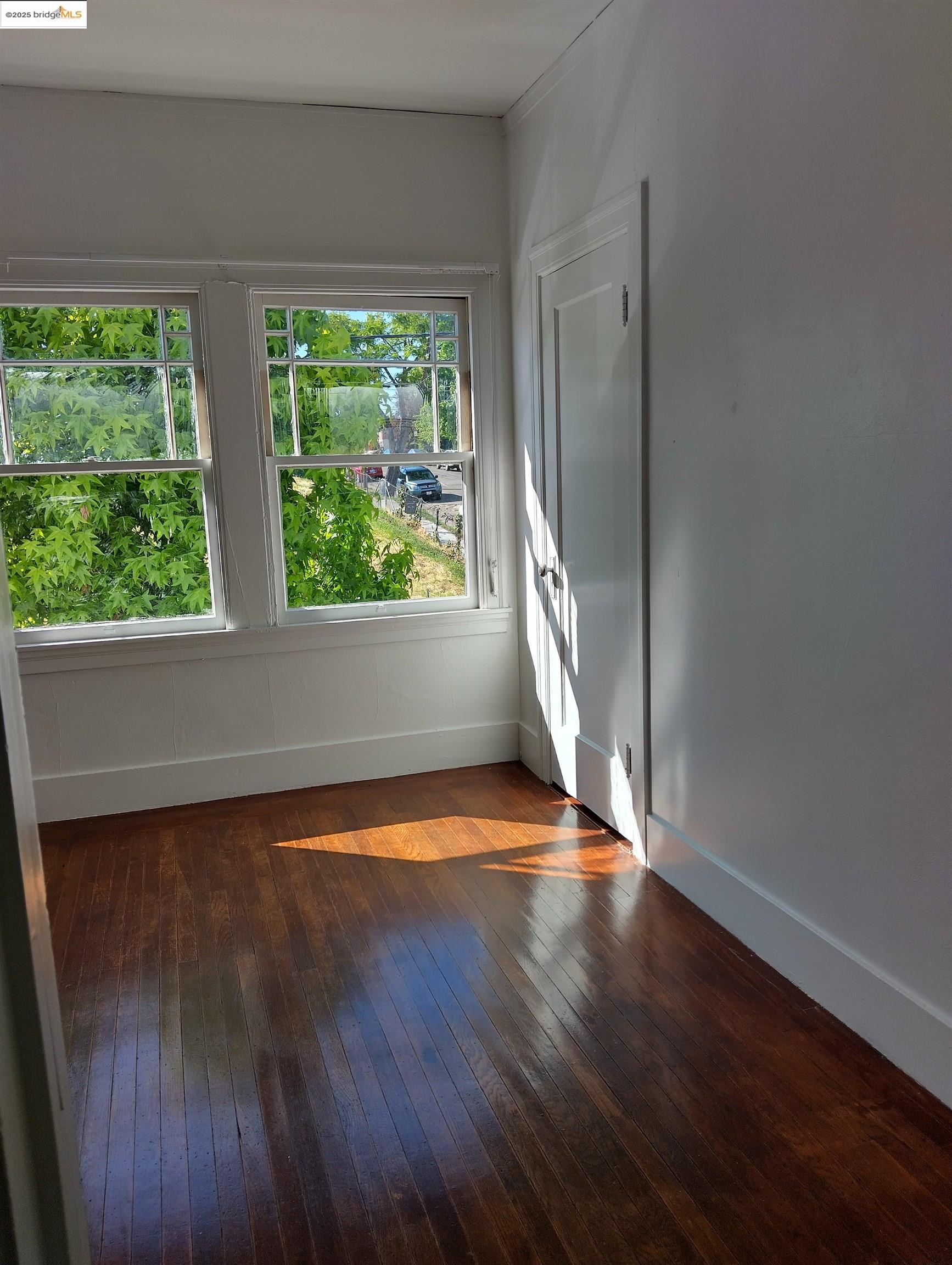 1864 11th Avenue Oakland, CA 94606 - Photo 12 of 46 a view of empty room with wooden floor and fan