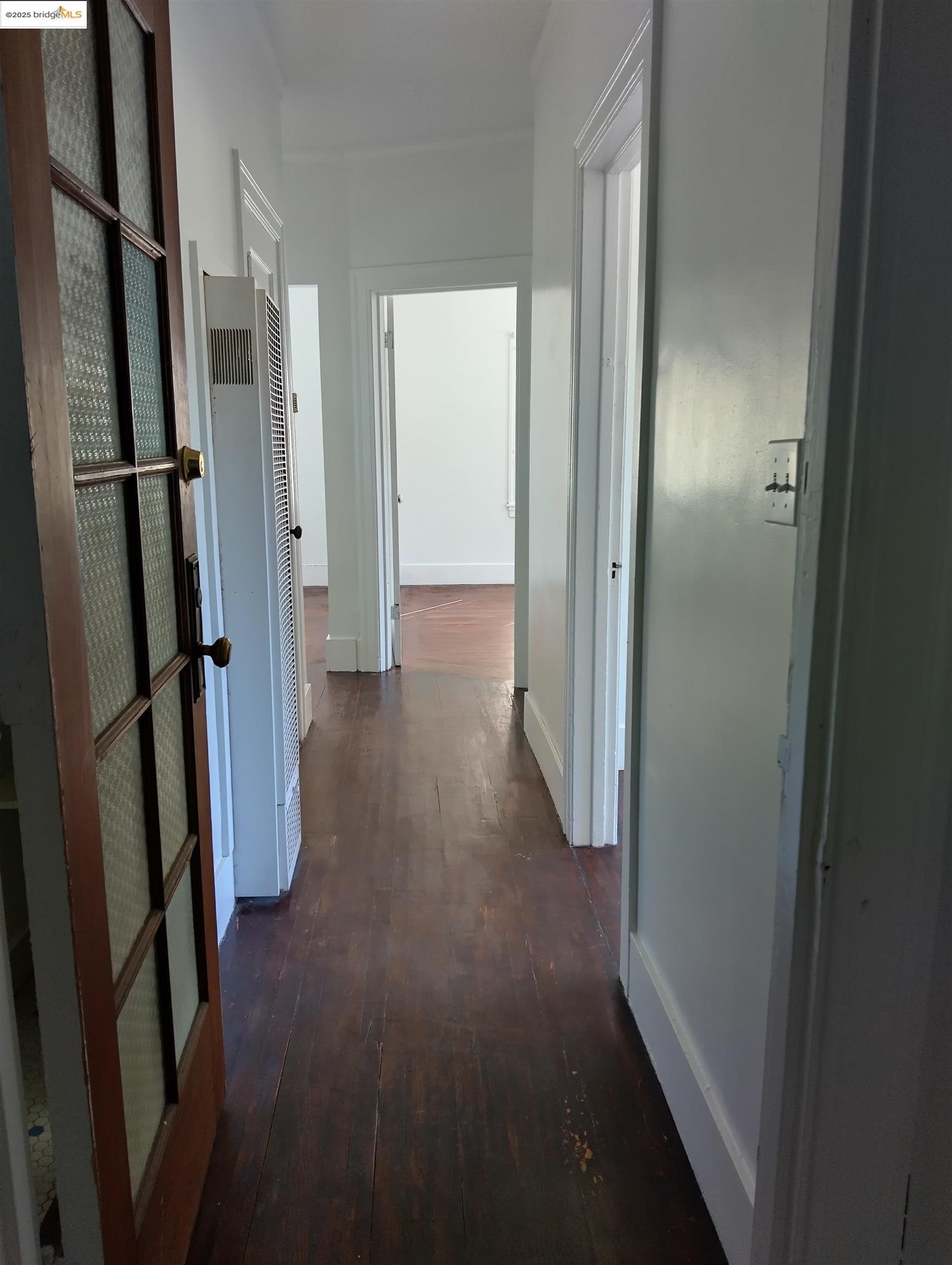 1864 11th Avenue Oakland, CA 94606 - Photo 14 of 46 a view of a hallway with wooden floor and staircase