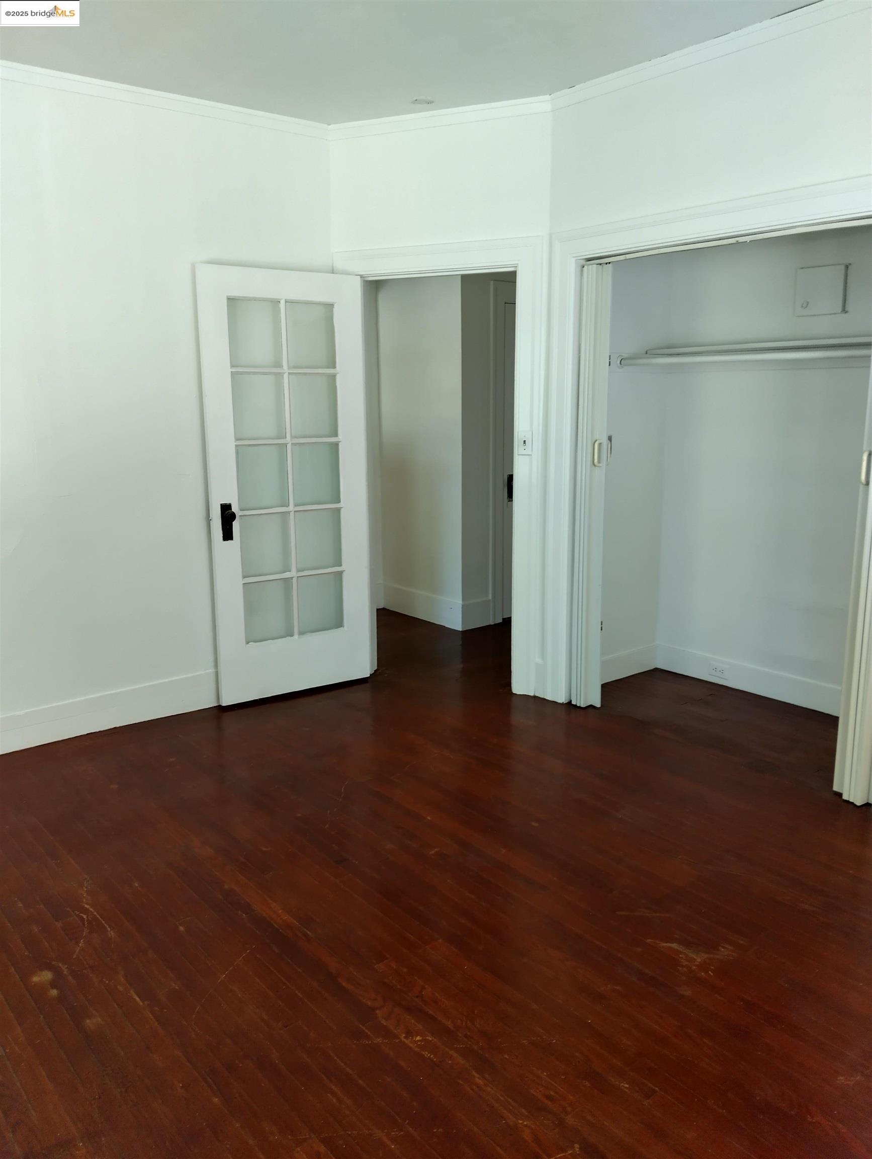 1864 11th Avenue Oakland, CA 94606 - Photo 25 of 46 an empty room with wooden floor & closet area