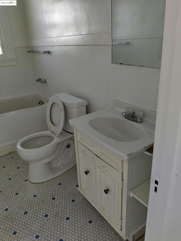 a white toilet sitting next to a bathroom sink