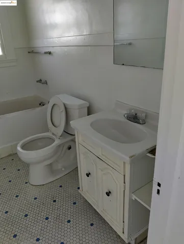 a white toilet sitting next to a bathroom sink