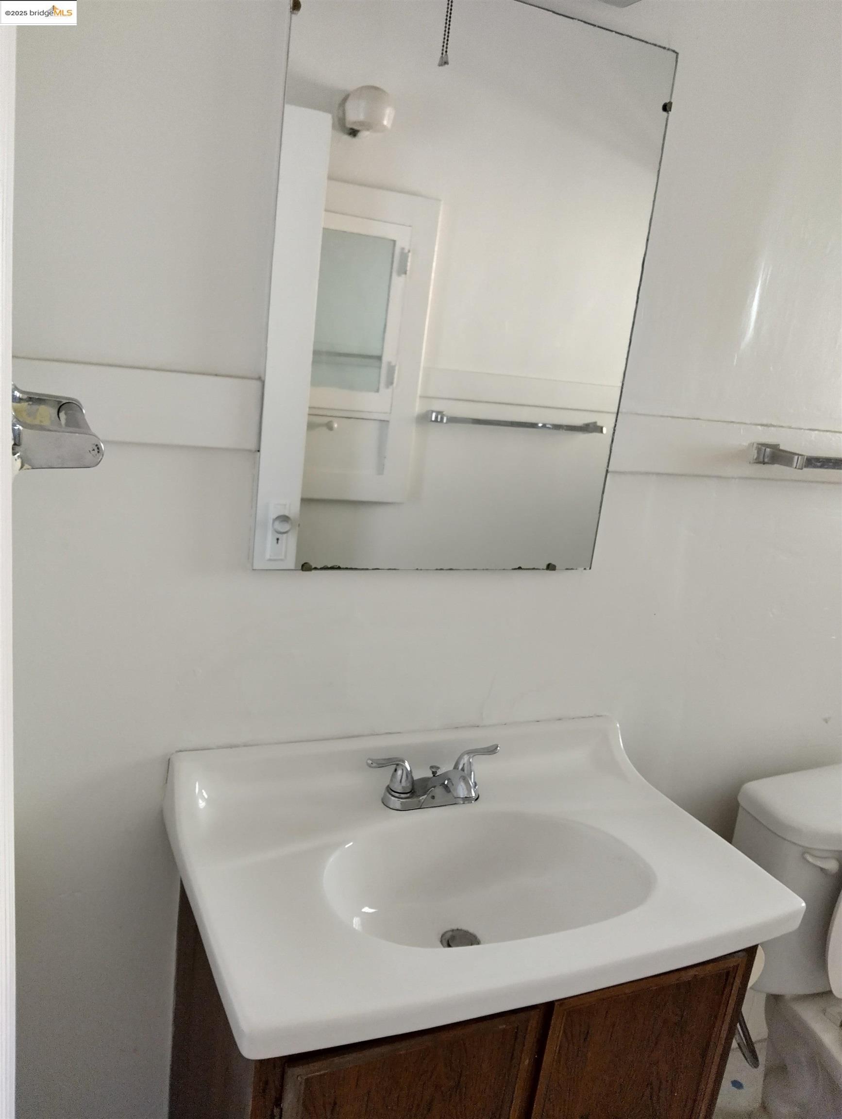1864 11th Avenue Oakland, CA 94606 - Photo 32 of 46 a bathroom with a sink and mirror