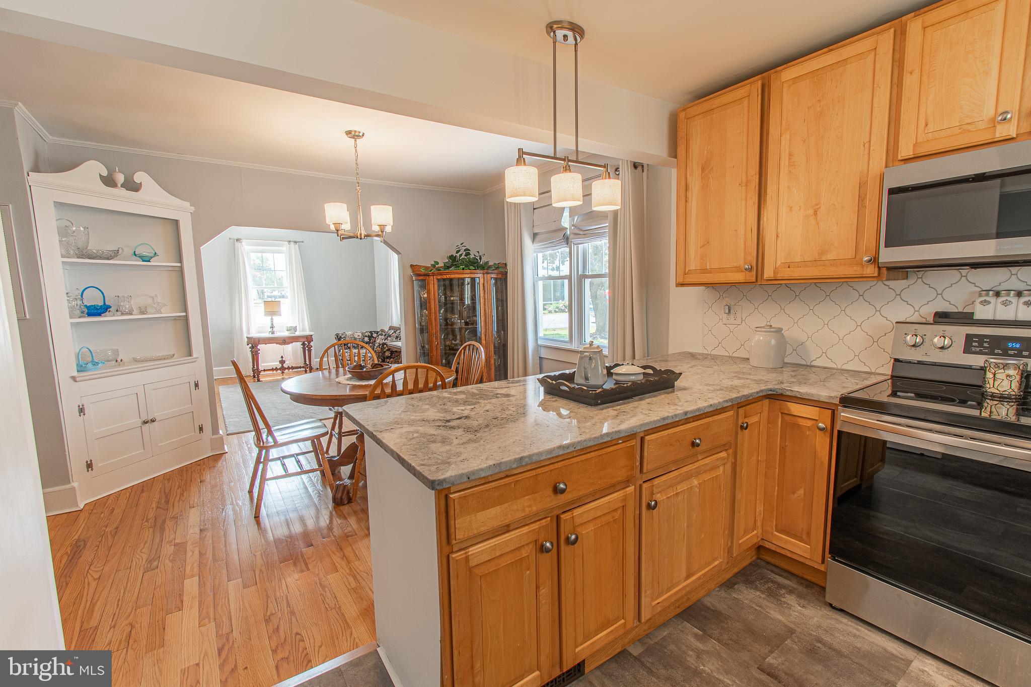 207 Crusader Road Cambridge, MD 21613 - Photo 29 of 76 a kitchen with sink cabinets and wooden floor