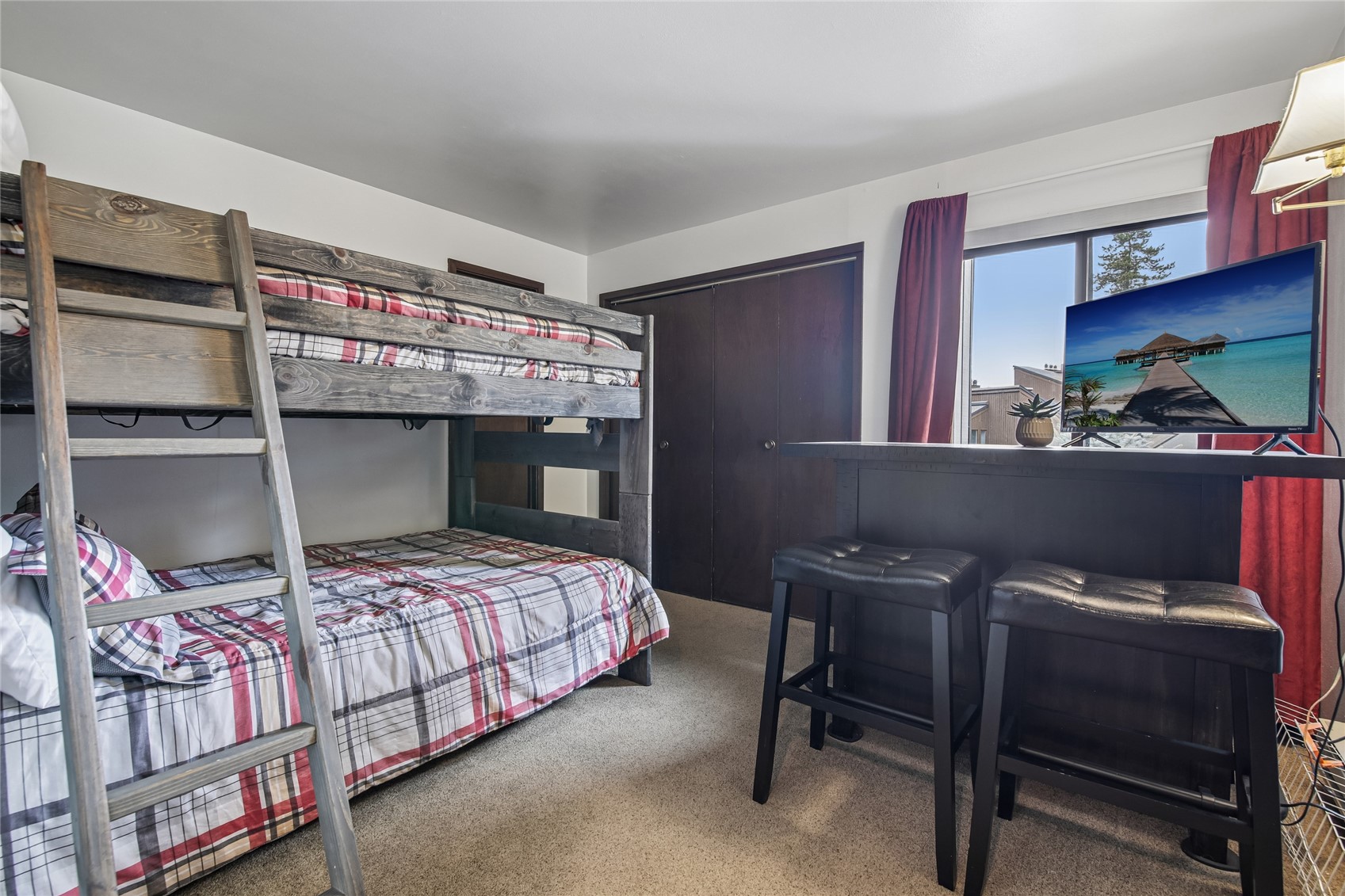 423 Wild Irishman Road, Unit 1008 1009 Keystone, CO 80435 - Photo 24 of 28 a bedroom with a bed a desk and chair