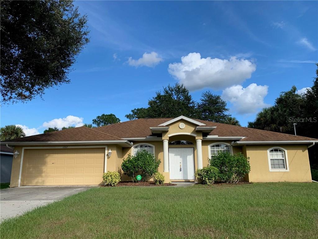 1262 Fitzgerald Road North Port, FL 34288 - Photo 1 of 1 a front view of a house with a yard and garage