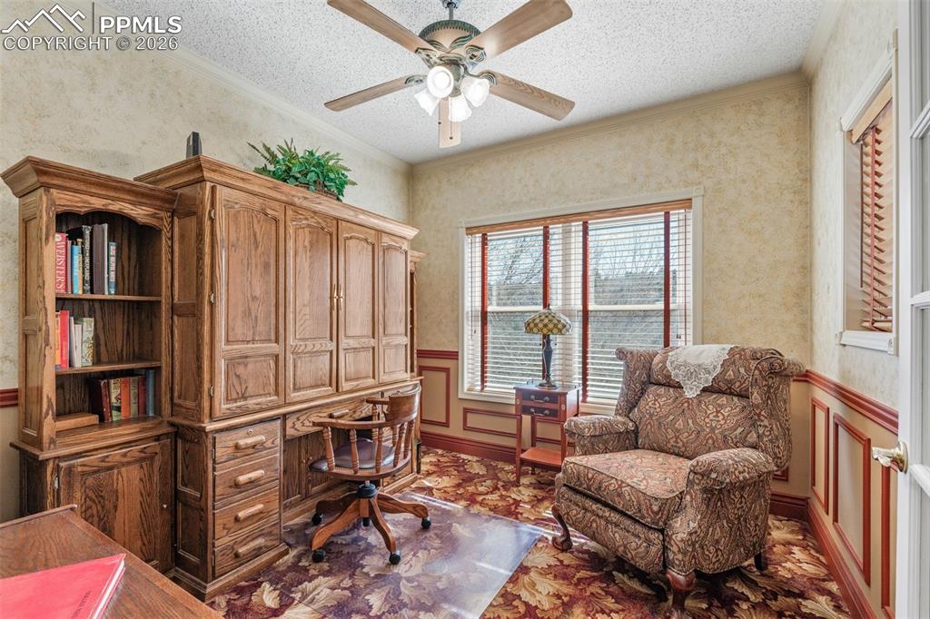 5440 Setters Way Colorado Springs, CO 80919 - Photo 11 of 40 a living room with furniture a window and a chandelier