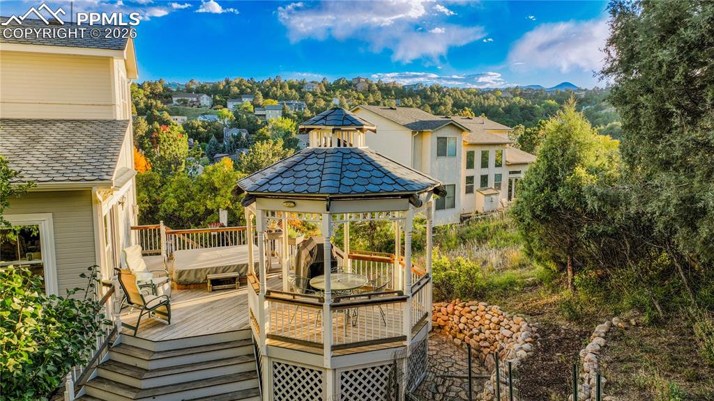 5440 Setters Way Colorado Springs, CO 80919 - Photo 2 of 40 a view of a patio with couches table and chairs and potted plants