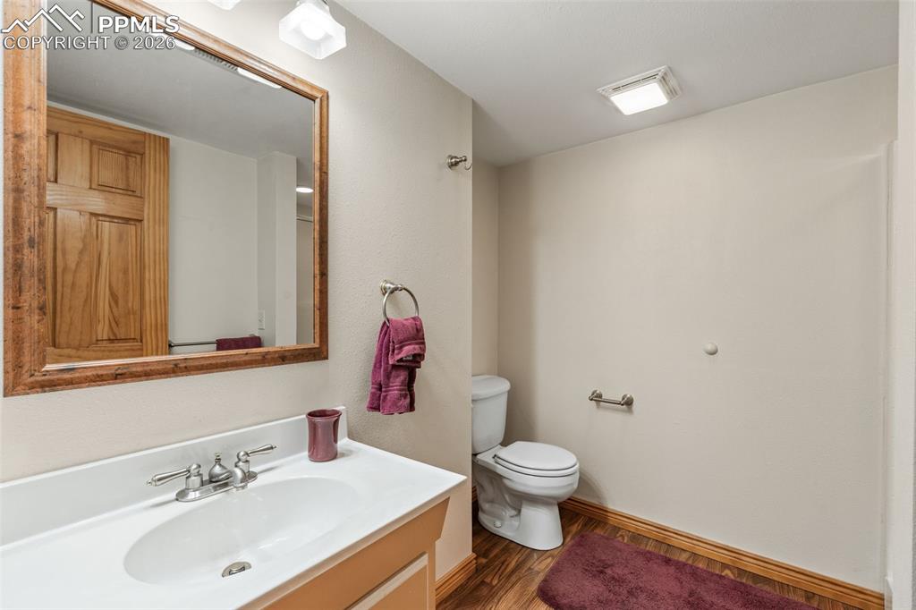 5440 Setters Way Colorado Springs, CO 80919 - Photo 31 of 40 a white toilet sitting next to a bathroom sink