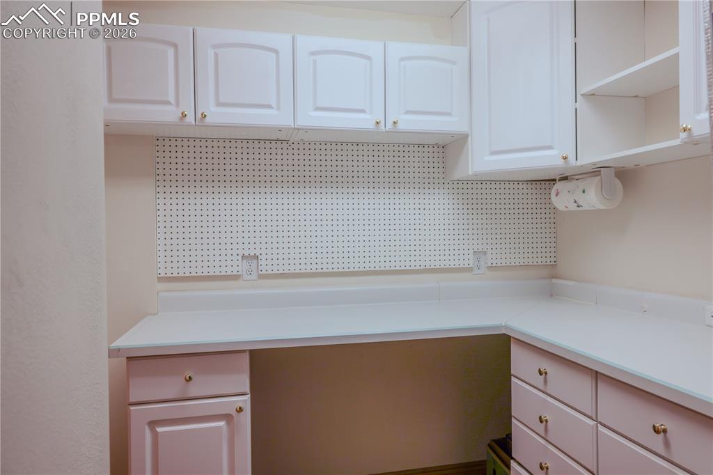 5440 Setters Way Colorado Springs, CO 80919 - Photo 32 of 40 a kitchen with cabinets and white appliances