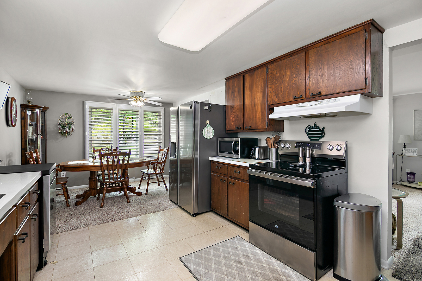 2 Jan Avenue Kankakee, IL 60901 - Photo 6 of 19 a kitchen with kitchen island granite countertop wooden cabinets a dining table and chairs